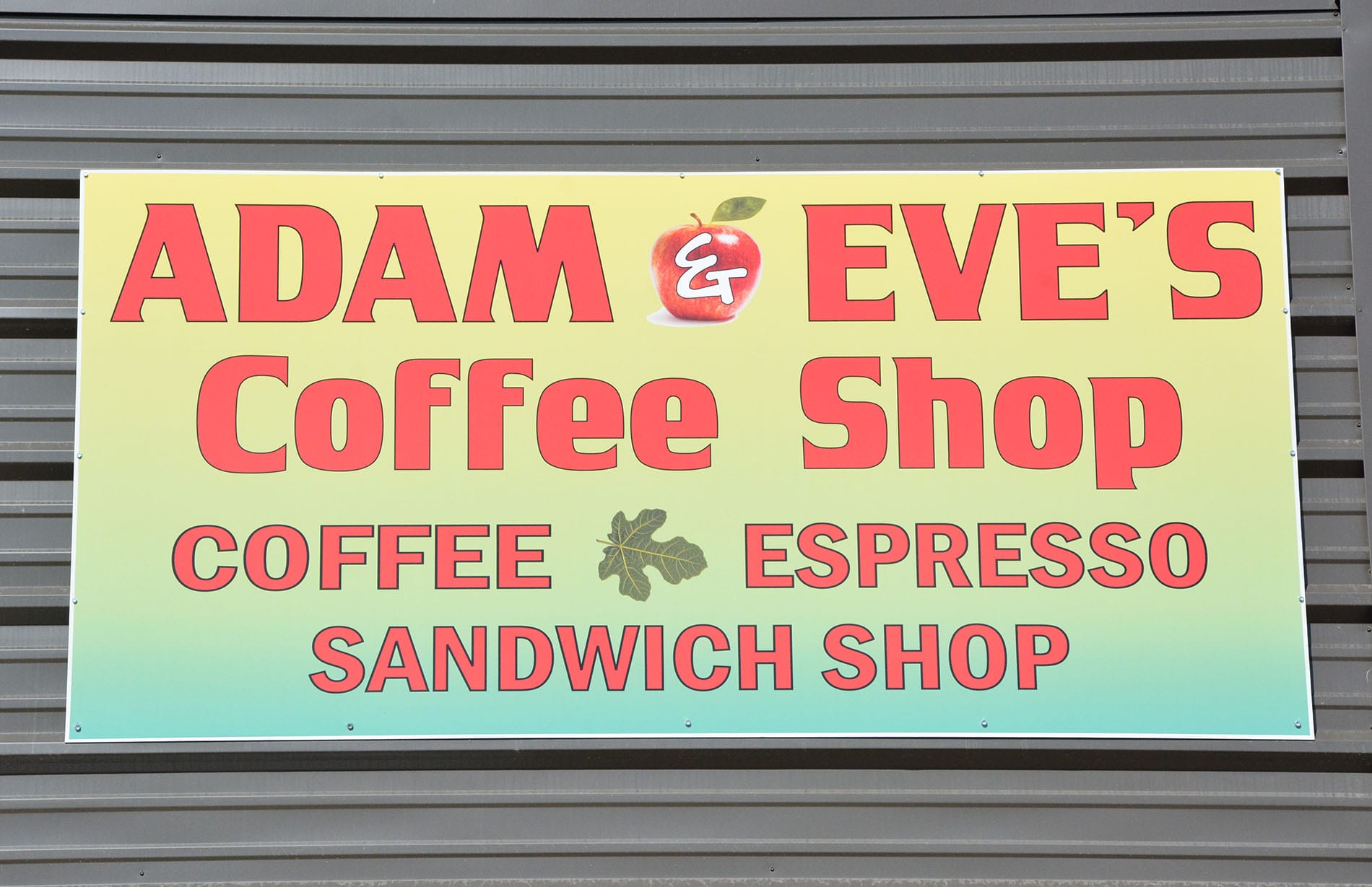 Green sign with Adam & Eves Coffee Shop