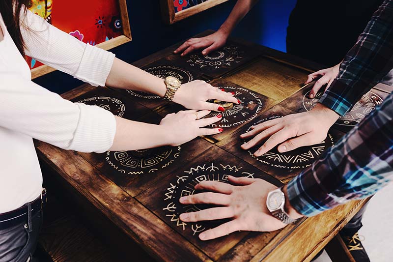 sets of hands on escape room puzzle.